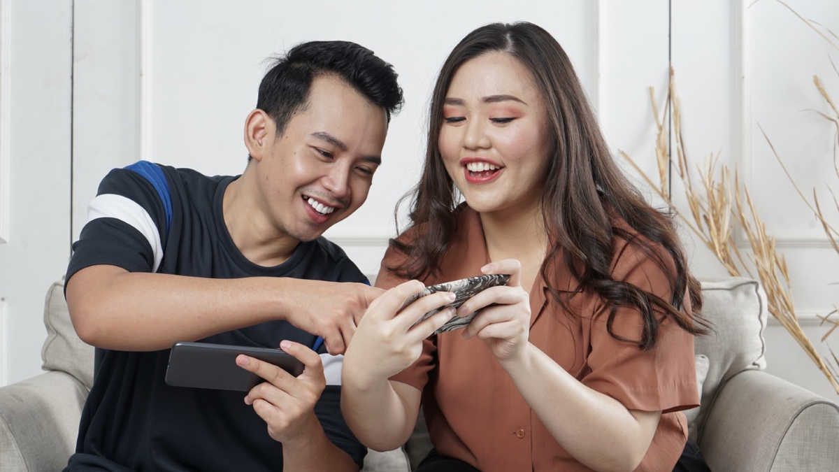 Couple enjoying the experience being offered to them on their smartphones